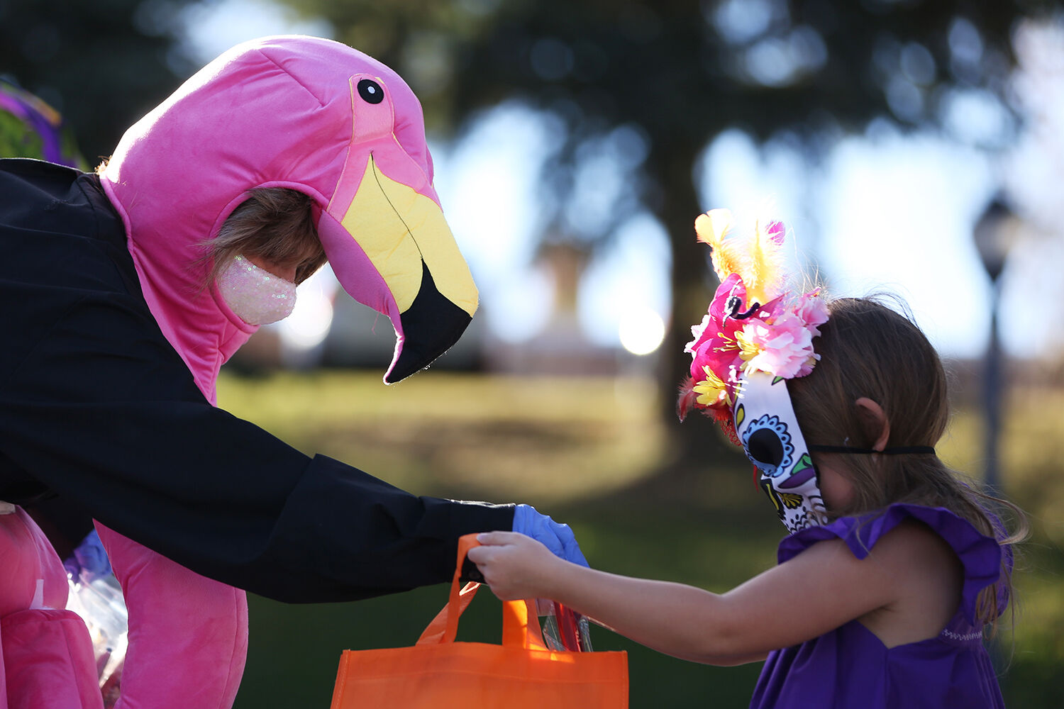 Flamingo Roxanne Ostlund drops a red kazoo into the bad of Norah Money